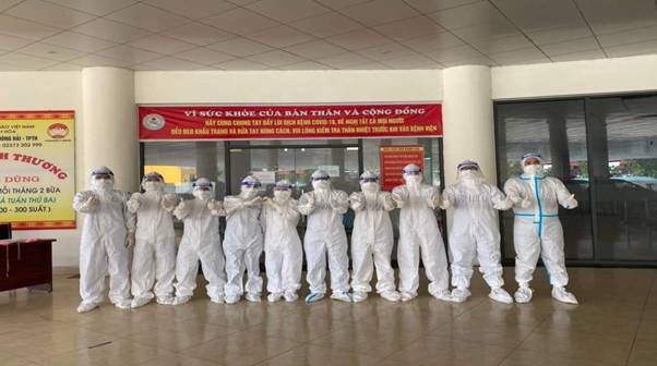 A group of people in white protective suits

Description automatically generated