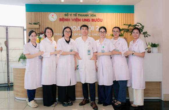 A group of people wearing white lab coats

Description automatically generated